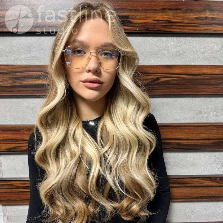 Photo after hair contouring — coloring of long light brown hair with a transition to lighter shades, facial feature enhancement